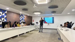 Digital strategy workshop in progress with a speaker Freddy Francis presenting content strategy concepts to participants seated around a conference room.