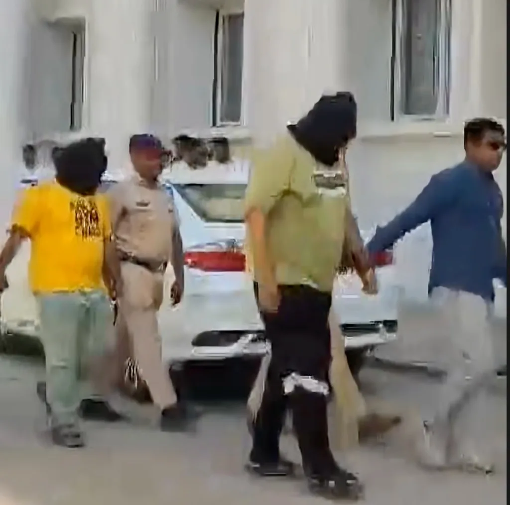 Nashik Police taking accused Raza Meman and Shafi Sheikh into custody for court production in the TCS Nashik case; screen grab from an ANI video report.