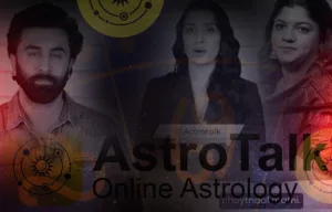 A promotional banner for the "Astrotalk Online Astrology" platform. The image features a dark, composite overlay of three individuals: Bollywood actor Ranbir Kapoor on the left, an unidentified woman in a black blazer in the center, and another woman on the right. The prominent text reads "AstroTalk" with the tagline "Online Astrology" underneath. The background includes faint astrological symbols, circular planetary graphics, and a subtle red tint on the outer edges.