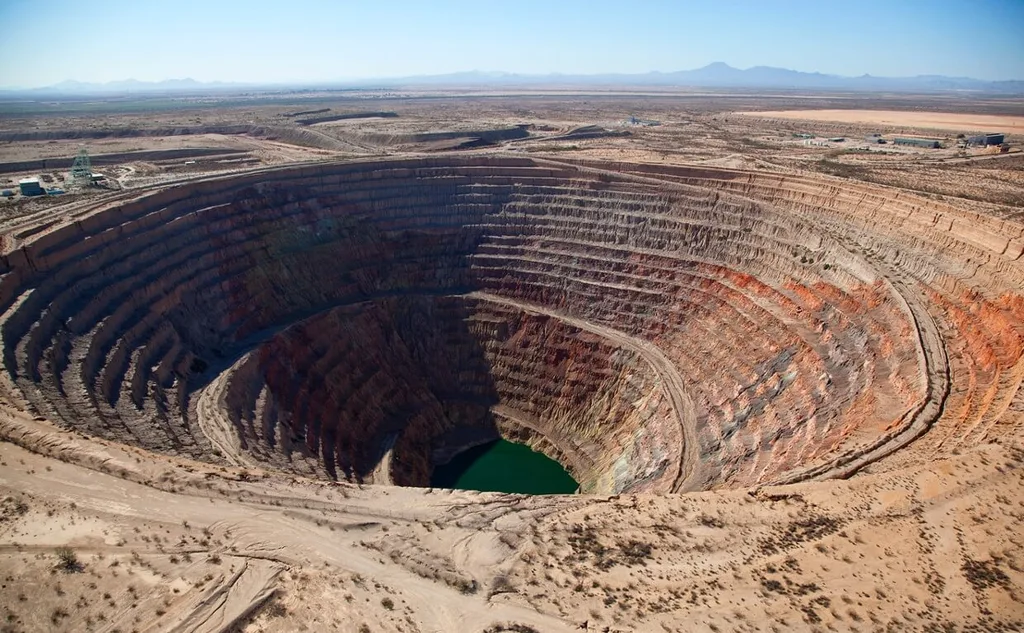 Open-cast coal mining site showing deforestation and environmental degradation